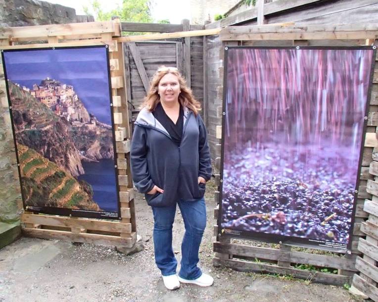 Tracy outside the exhibition with two photos displayed inside. Eighth Annual Terroirs d'Images International Photo Exposition.