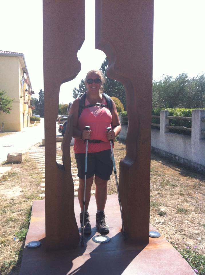 Tracy walking through the pilgrim sculpture in Obanos
