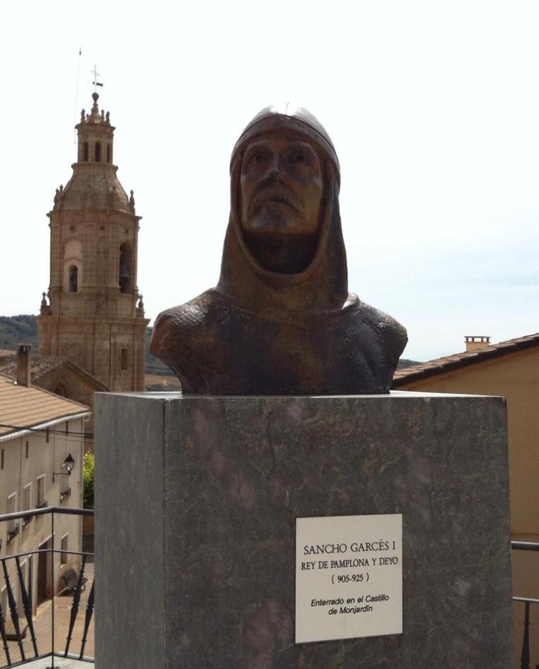 Bust of Sancho I and bell tower of San Andres, 12th century, in Villamayor
