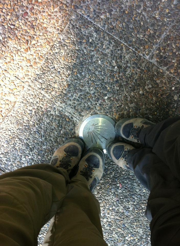 Standing over one of the Camino markers in Pamplona