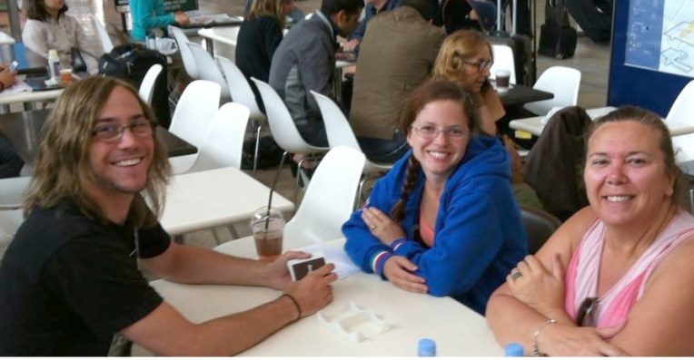 Casey, Megan. and Tracy playing cards and waiting for the train.