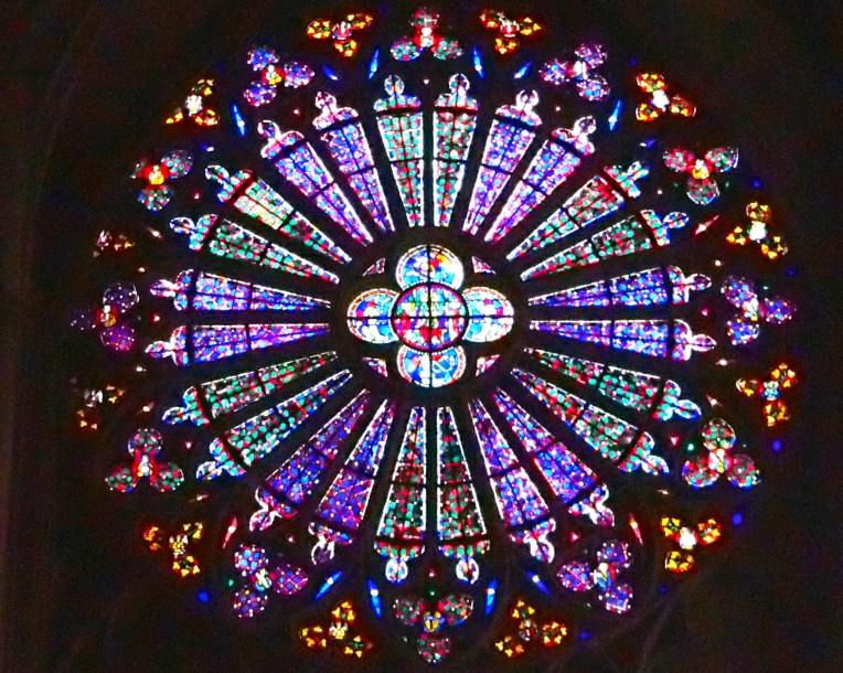 Rose window stained glass is Basilique Saint-Nazaire-et-Saint-Celse de Carcassonne (Basilica of St. Nazaire and St. Celse) within le Cité de Carcassonne.