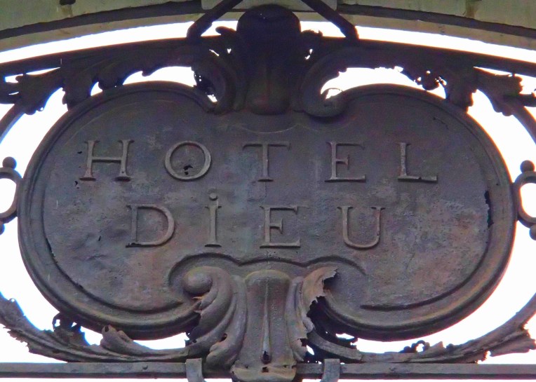 The antique sign above the entrance to the former Hôtel Dieu (God's Hotel)  which was built in 1772 as a city hospital.  The hospital was demolished in 1977 and all that remains today is the entrance gate and Le Dôme, the former bell tower to the hospital's chapel. 