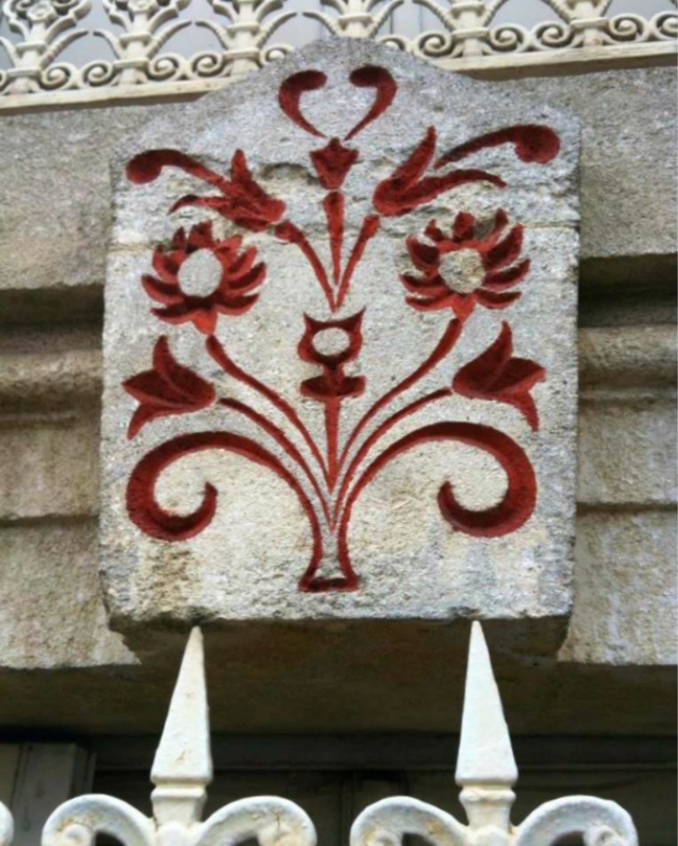 Decorative stonework above the windows of a residence on Boulevard Barbes.