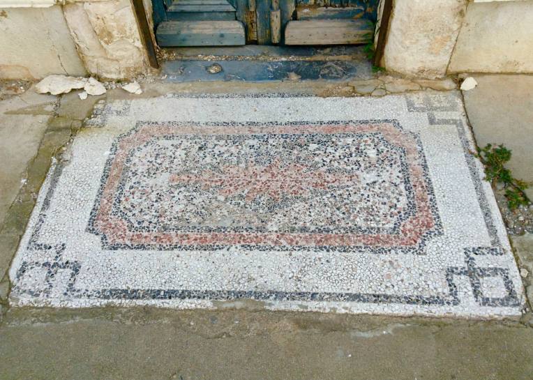An old mosaic welcome mat.