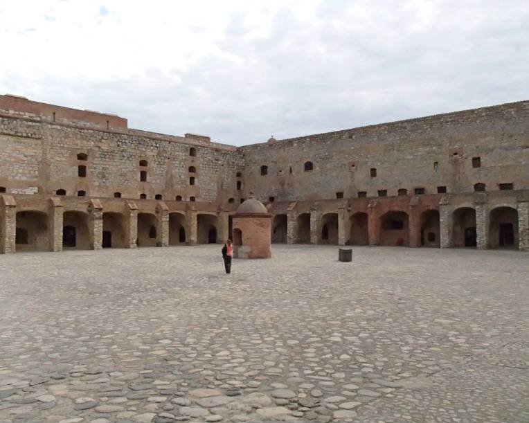 Tracy walking over to see the well in the center of the courtyard.