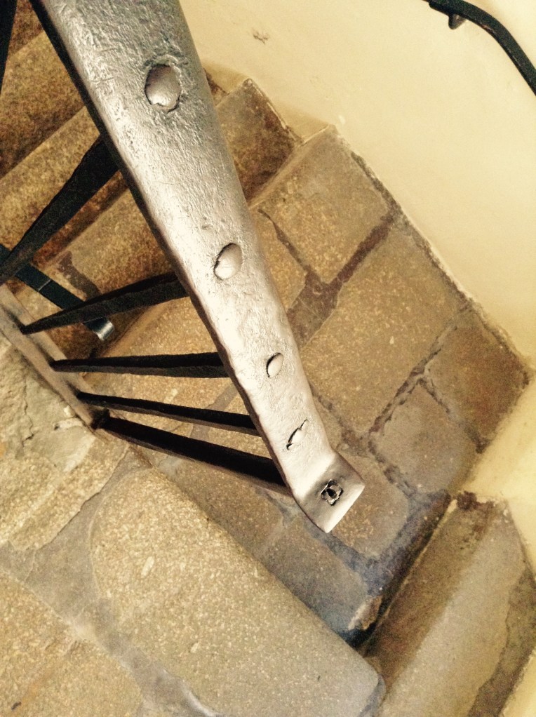 Staircase with handcrafted metal railing.